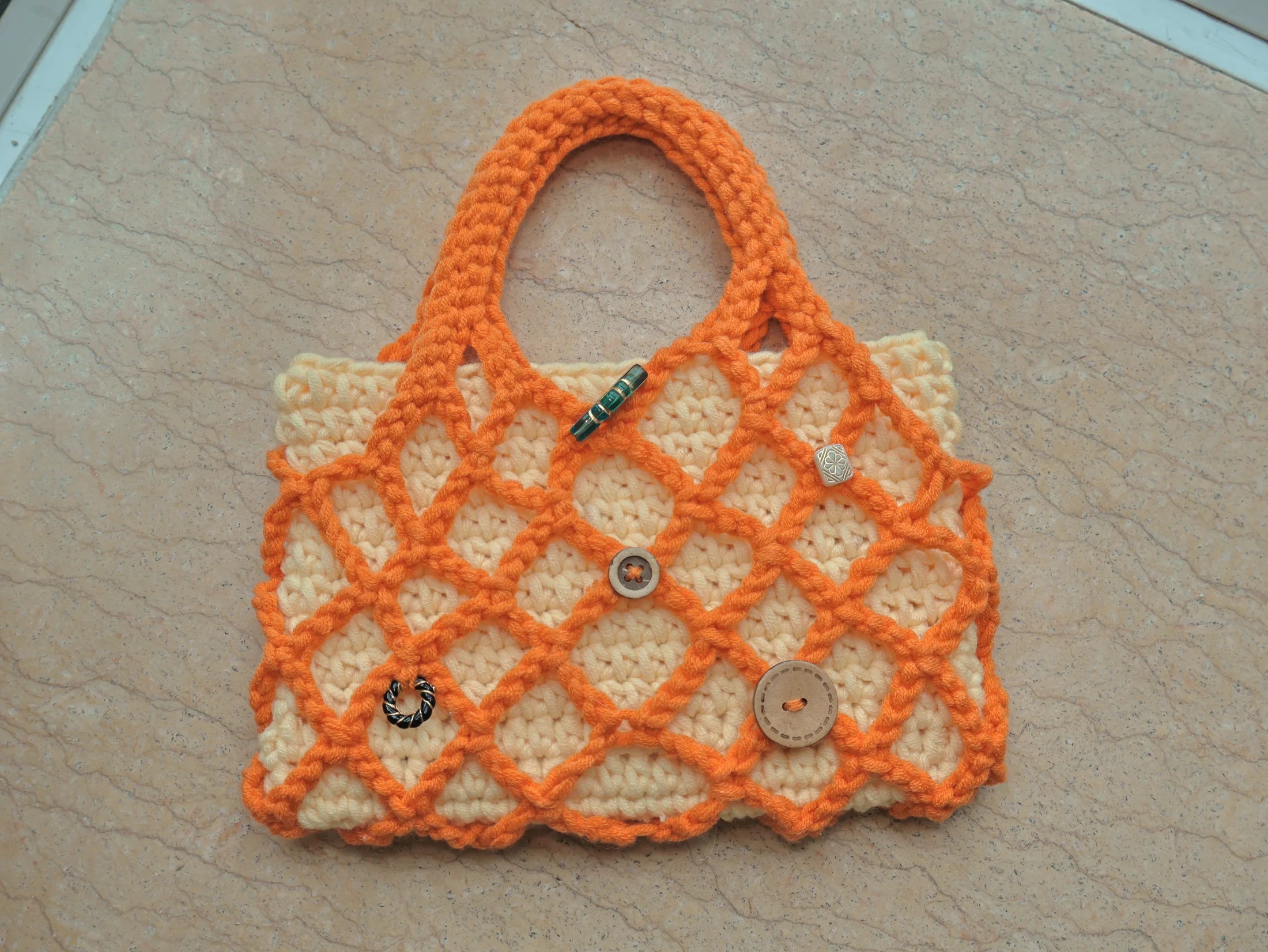 Orange and cream hand-knitted lattice bag