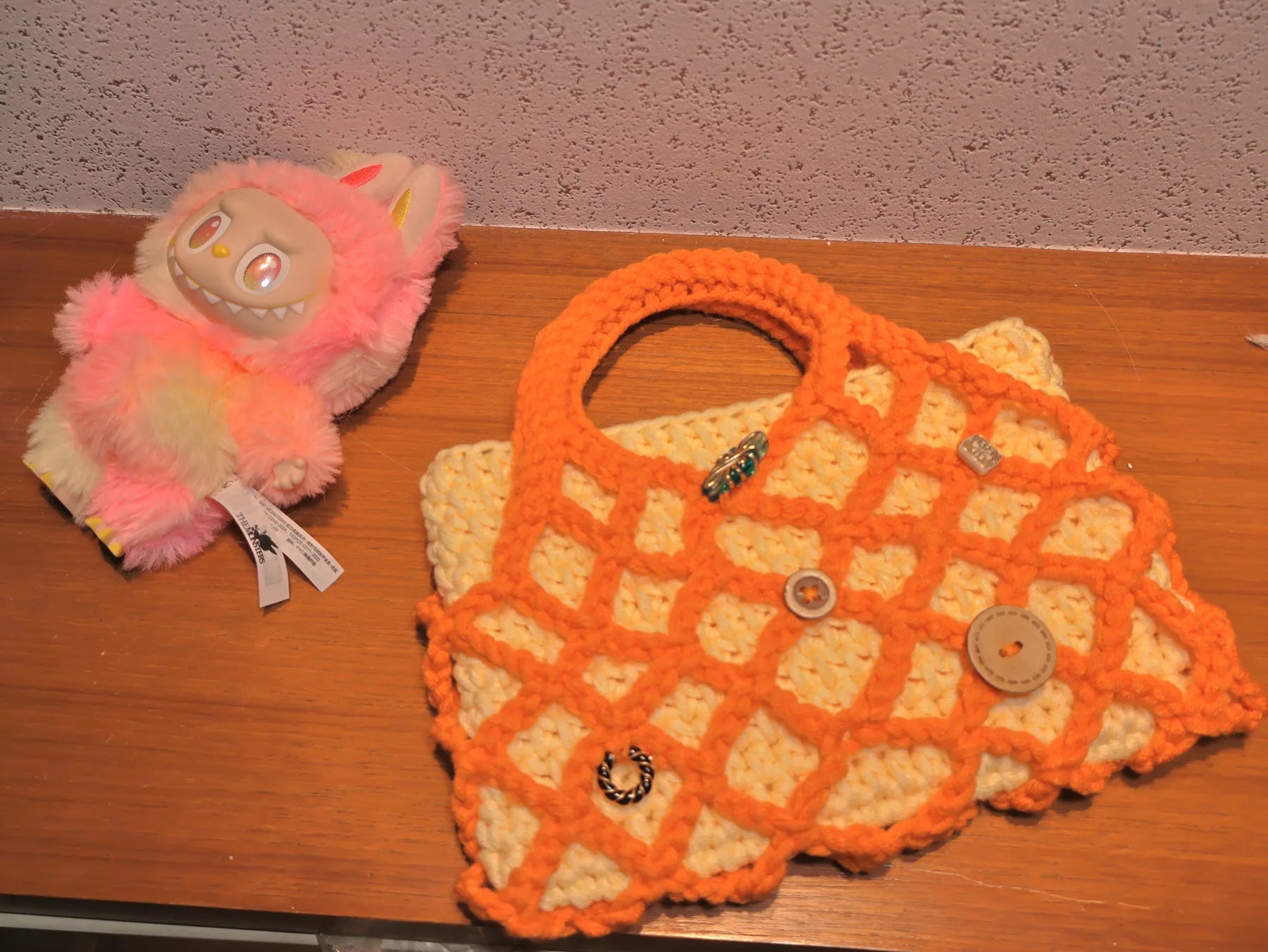 Orange lattice bag styled with a playful studio object