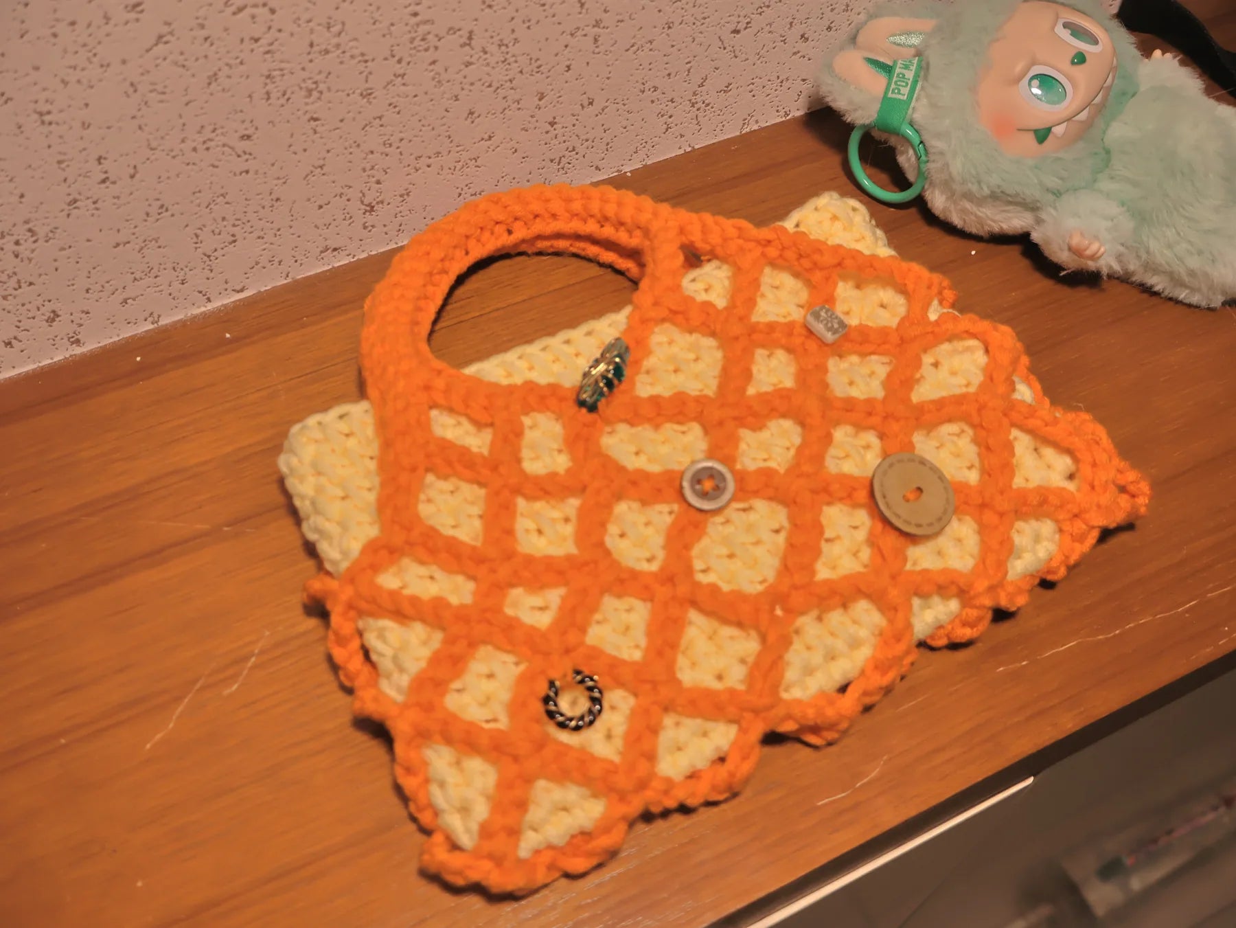 Orange lattice bag photographed at an angle